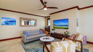 Bright open concept living room featuring a high-end couch with a queen sofa bed