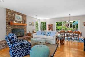 Living room with fireplace, TV - open to dining area and kitchen.