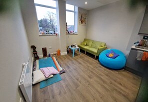 Living room with sofa-bed and exercise, yoga or floor lounge area