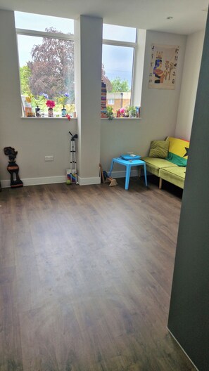 Minimalistic living room with a touch of colour and art. Reading books avail