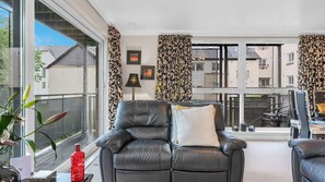 Bright living room with lush sofas and Flat-screen TV