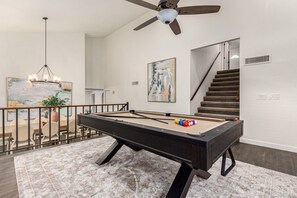 Mid-Level Billiards Area with Sofa and Smart TV