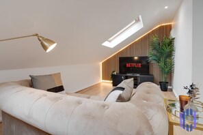 Living room  - 50'  Smart TV loaded with Netflix, ambient lighting,  extra fast Wi-Fi - Complimentary tea & coffee available for your enjoyment