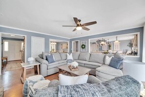 Living room on main level, with TV on mantle of fireplace. Plenty of seating for large group. New updates throughout.