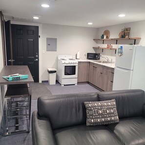 Toaster oven, hot plate, coffee pot, frig, microwave, wine opener, pizza cutter, dishes, silverware, coffee cups, etc. 