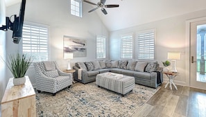 Sunlit and spacious living area, featuring an abundance of windows for a bright and airy atmosphere.