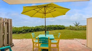 "Relax on the patio only steps away from the beach."
