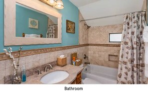 "Elegant master bath with a calming coastal theme and modern fixtures."