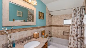 "Elegant master bath with a calming coastal theme and modern fixtures."