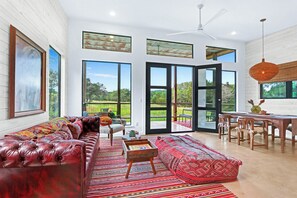 Large windows and double doors bring the outdoors inside