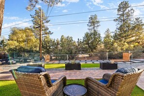 Enjoy the lush green landscape, offering a peaceful and refreshing backdrop to your outdoor retreat.