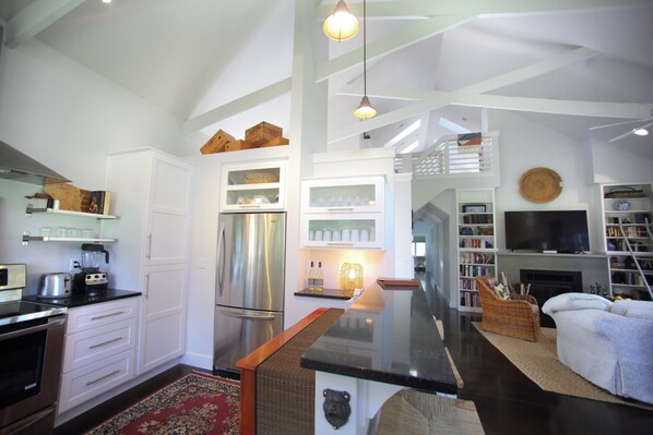 Open concept kitchen, unique architecture, and cozy furnishings