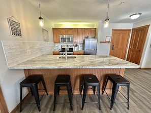 "Indoors","Floor","Kitchen","Refrigerator","Furniture"