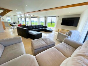 Plenty of comfy loungers to sit and enjoy the large Smart TV. 