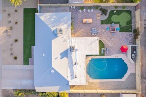 Large fenced in backyard with private heated pool, mini golf, and a separate fence around the pool 