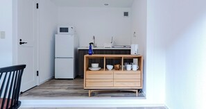 Kitchen with refrigerator, microwave, tableware, and cooking utensils are free to use.