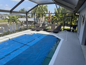 Heated pool with screened enclosure for year-round enjoyment.