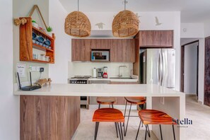 There’s a breakfast bar with stools for dining indoors
