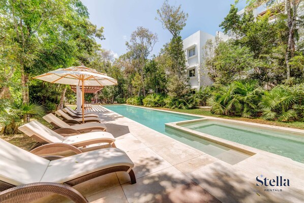 A glorious place to spend the day at the pool onsite with cushioned loungers