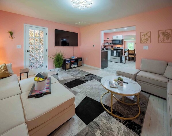 Lots of comfy couch space to lounge on!  Large 65" Smart TV!