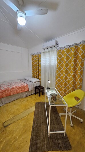 Queen-size bed, blackout curtains, A/C, ceiling fan and dedicated workspace