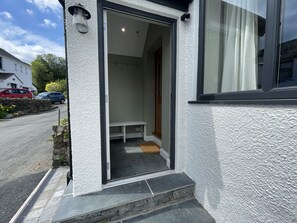 The front door leads into a porch with space for coats and boots