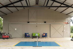 Party Barn features Dinking Court, basketball goal, ping-pong, mini basketball arcade, Bluetooth speakers & more!