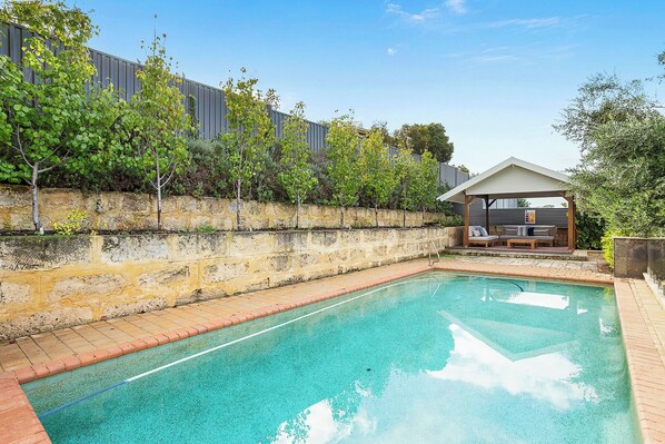 Outdoor pool with outdoor seating undercover