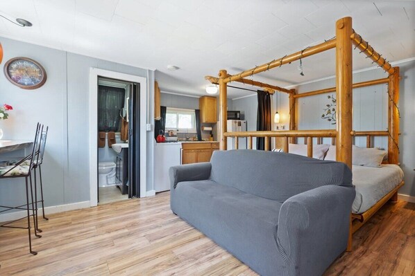 Studio Retreat: Rustic log bed paired with open space, perfect for relaxation and adventure!