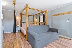 Rustic Retreat: Charming four-poster bed and inviting sitting area await your mountain getaway!