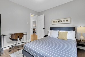 Bright and inviting bedroom featuring a modern desk, ideal for work or leisure.