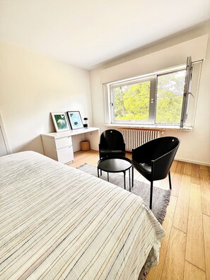 BNB near Ghent: 
small desk and vintage seating in room with graden view 