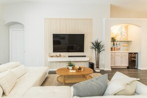 -Enjoy a flat-screen TV with streaming options, perfect for movie nights or catching up on your favorite shows.  -Soft, ambient lighting enhances the cozy and inviting atmosphere.