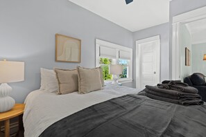 This bedroom offers a sanctuary of comfort and sophistication, inviting the occupant to unwind and recharge in a space that reflects a thoughtful and intentional approach to interior design.