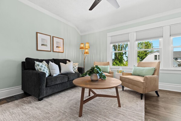 This inviting living space radiates a warm and welcoming atmosphere, seamlessly blending modern elegance with timeless charm.