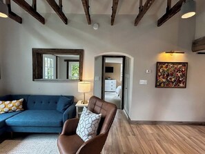 Living room looking toward bedroom one and front entry to the house