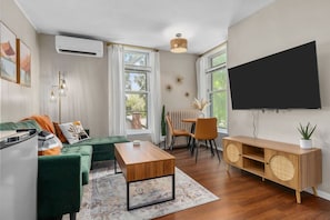 The comfortable and cozy living area has lots of natural light! Relax while reading, visiting or watching tv!