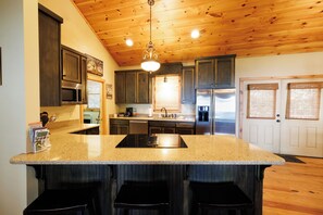 Well Stocked Kitchen with stove top facing towards the view. 