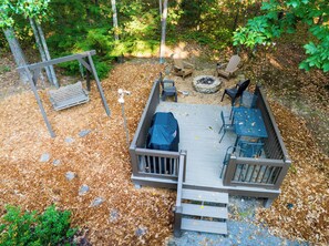 Aerial View of the backyard:
- Fire Pit (wood provided)
- Propane Grill
- Outdoor Dining Table Seats 4
- Swing Bench