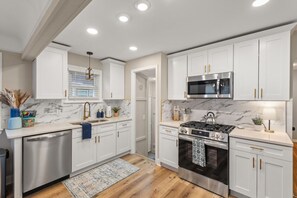 Who else is feeling major kitchen envy right now? White cabinets and hardwood floors give off sleek vibes that make meal prep feel like a stylish affair. Upgrade your cooking space with this trendy look! 🌟 #KitchenRenovation