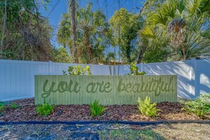 Charming backyard with a whimsical "You Are Beautiful" sign, perfect for fun photo ops and creating lasting memories
