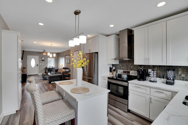 Fully updated kitchen with a clean design and a stylish bar area