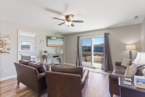 Enjoy the beautiful, open-concept living area with a large flat screen TV and cozy furniture.