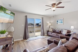 Enjoy the beautiful, open-concept living area with a large flat screen TV and cozy furniture.