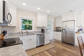 The kitchen with modern appliances is the perfect spot to whip up something delicious for the whole family to enjoy.