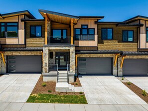 New townhome with a 2-car garage and parking in the driveway