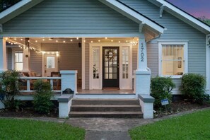 Charming exterior with a welcoming front porch and beautifully landscaped yard.