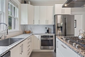 Sleek and modern design meets functionality in this fully stocked kitchen.