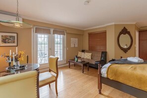 Bright bedroom with classic furniture and large windows for natural light
