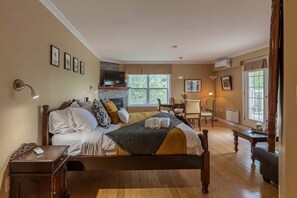 Relax in this elegantly styled bedroom with decorative cushions and towels